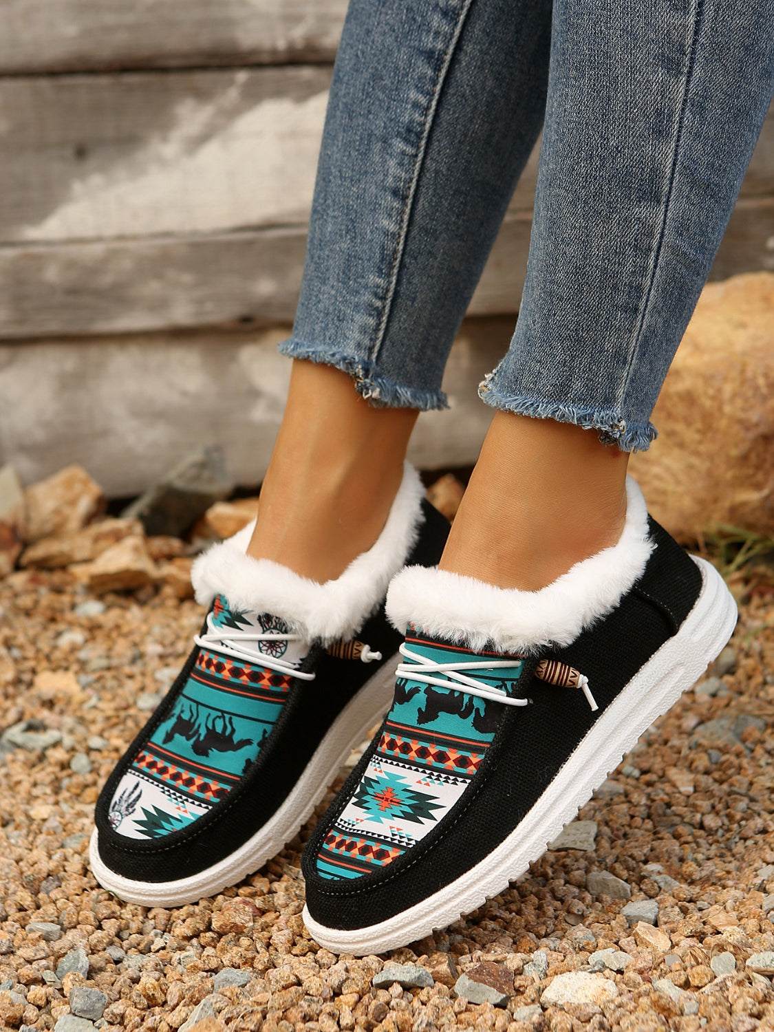 Printed round toe flat slip-ons with faux fur trim and tribal pattern, made of cotton and EVA.