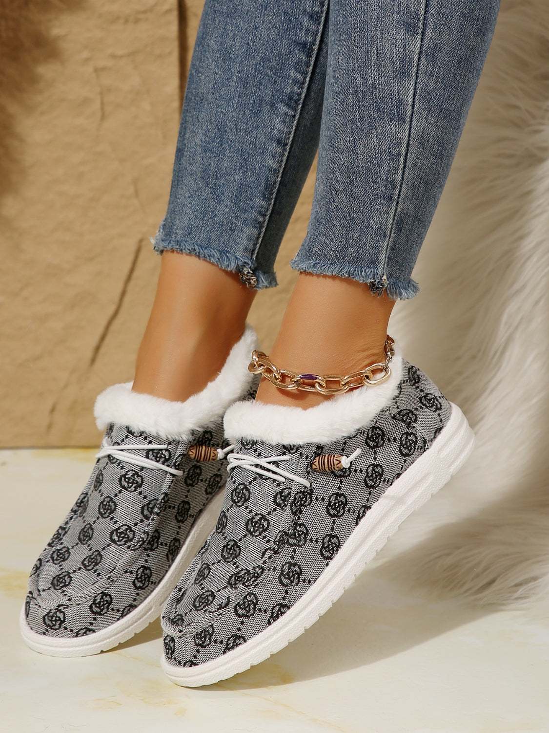 Printed round toe flat slip-ons with faux fur, grey pattern, and white soles.