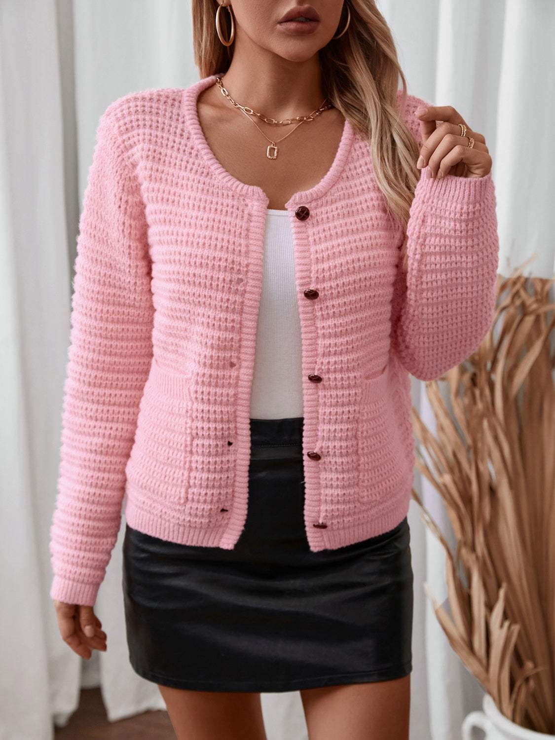 Pink button-up long sleeve cardigan with pockets, slightly stretchy, polyester material.