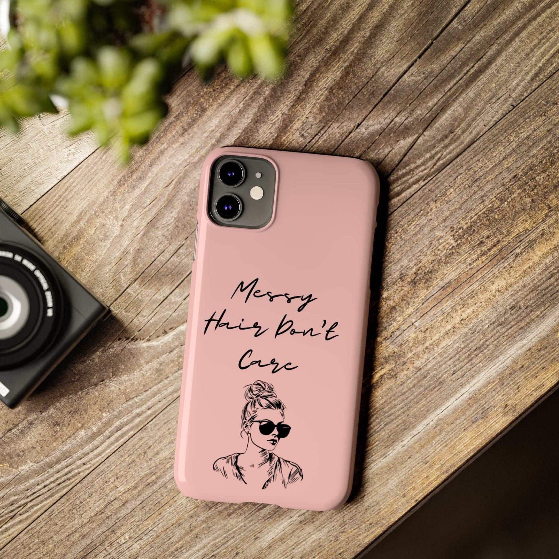 Baby pink phone case with "Messy Hair, Don't Care" and messy bun design, trendy and durable.