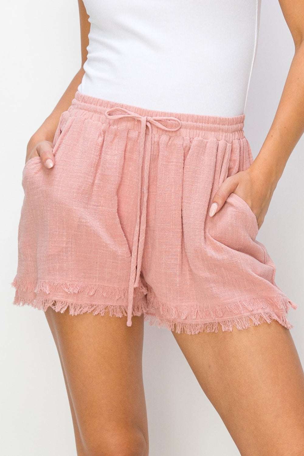 HYFVE Drawstring Frayed Shorts in pink with adjustable waist and frayed edges.