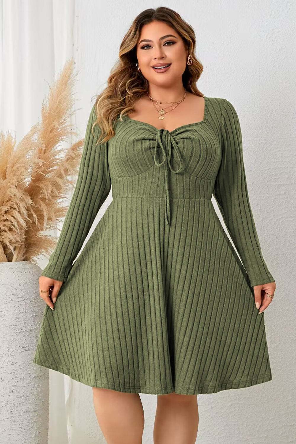 Plus size ribbed dress with sweetheart neck and long sleeves in green.