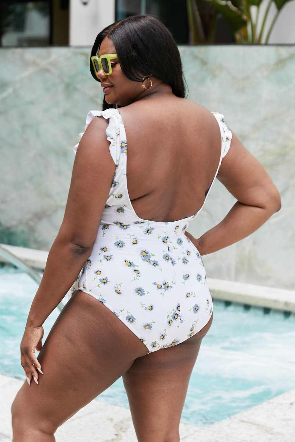 Marina West Swim Float On Ruffle Faux Wrap One-Piece in Daisy Cream worn by woman near pool.