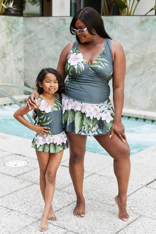 Marina West Swim Full Size Clear Waters Swim Dress in Aloha Forest floral print, worn by two people poolside.