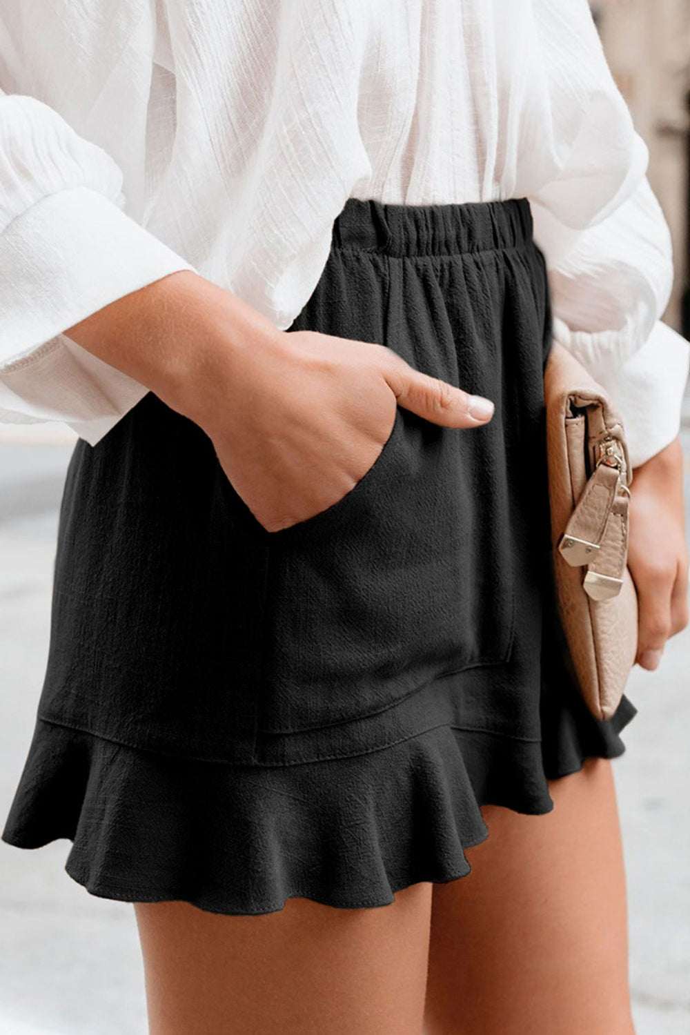 Full Size Ruffled Elastic Waist Shorts in black with side pockets and ruffled hem.