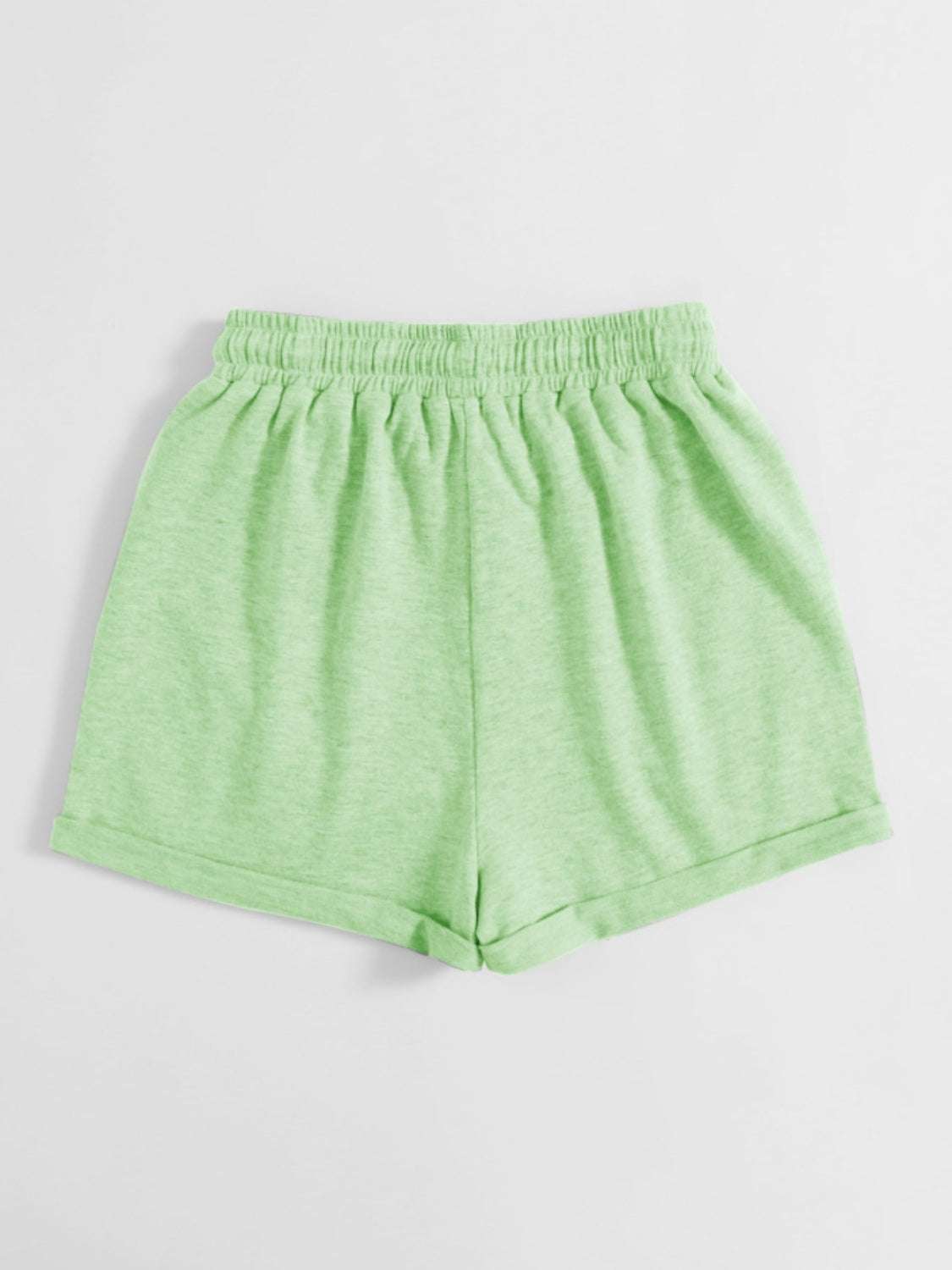 Green drawstring pocketed elastic waist shorts made from polyester.