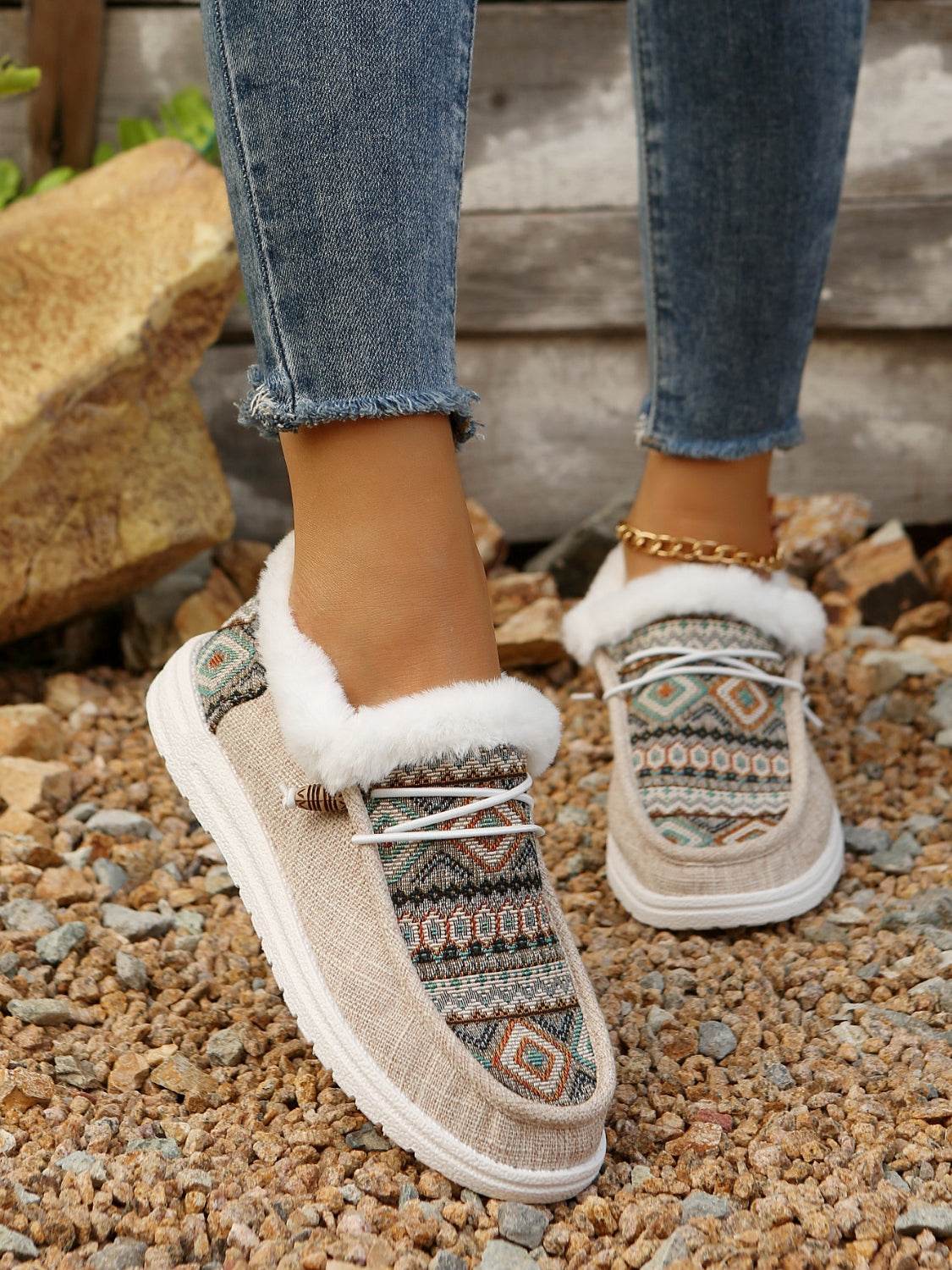 Printed round toe flat slip-ons with faux fur and cotton material, shown in outdoor setting.