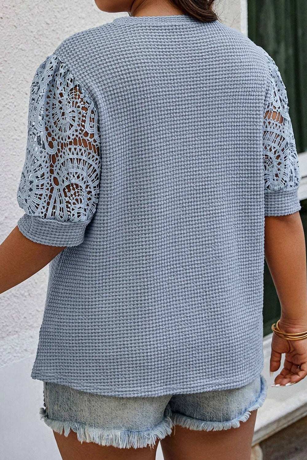 Plus size blue openwork round neck half sleeve blouse in waffle texture.