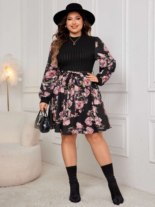 Plus-size tied printed long sleeve dress with floral pattern.