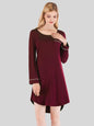 Woman wearing burgundy round neck night dress with a pocket.