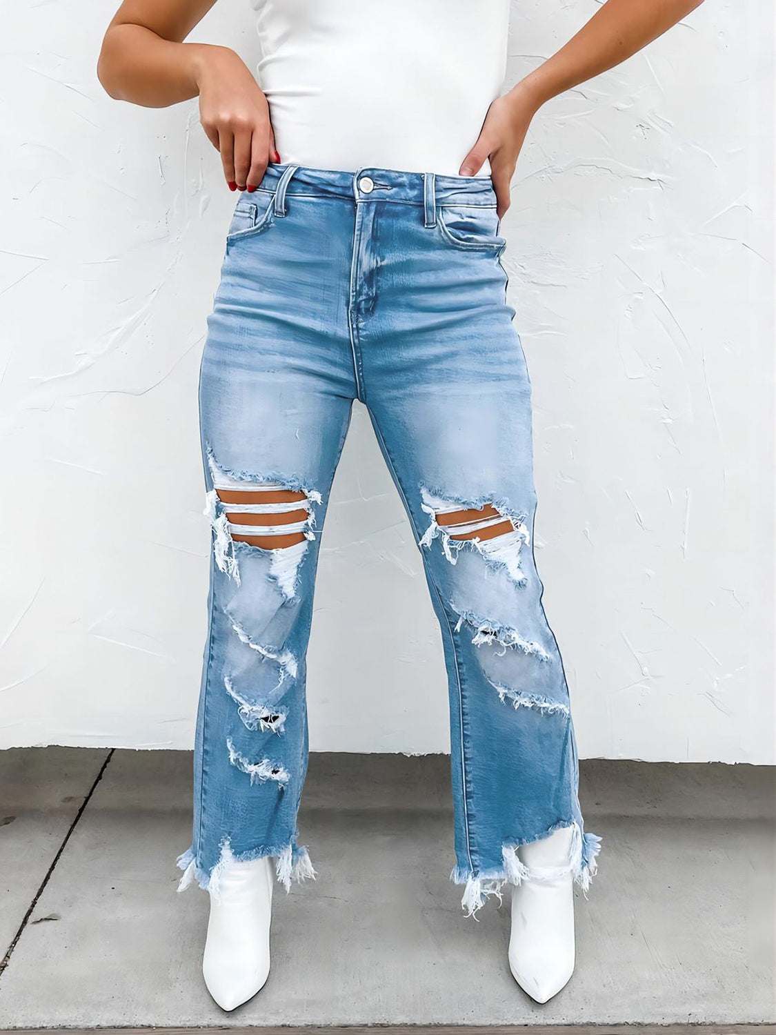 Distressed raw hem jeans with pockets and moderate stretch.