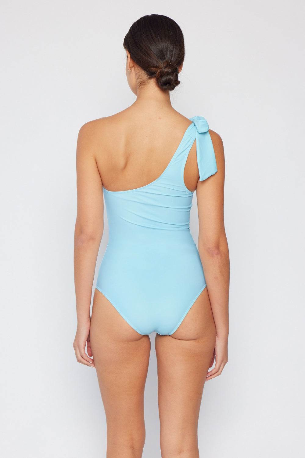 Pastel blue one-shoulder swimsuit featuring a tie detail on the strap, designed by Marina West Swim.