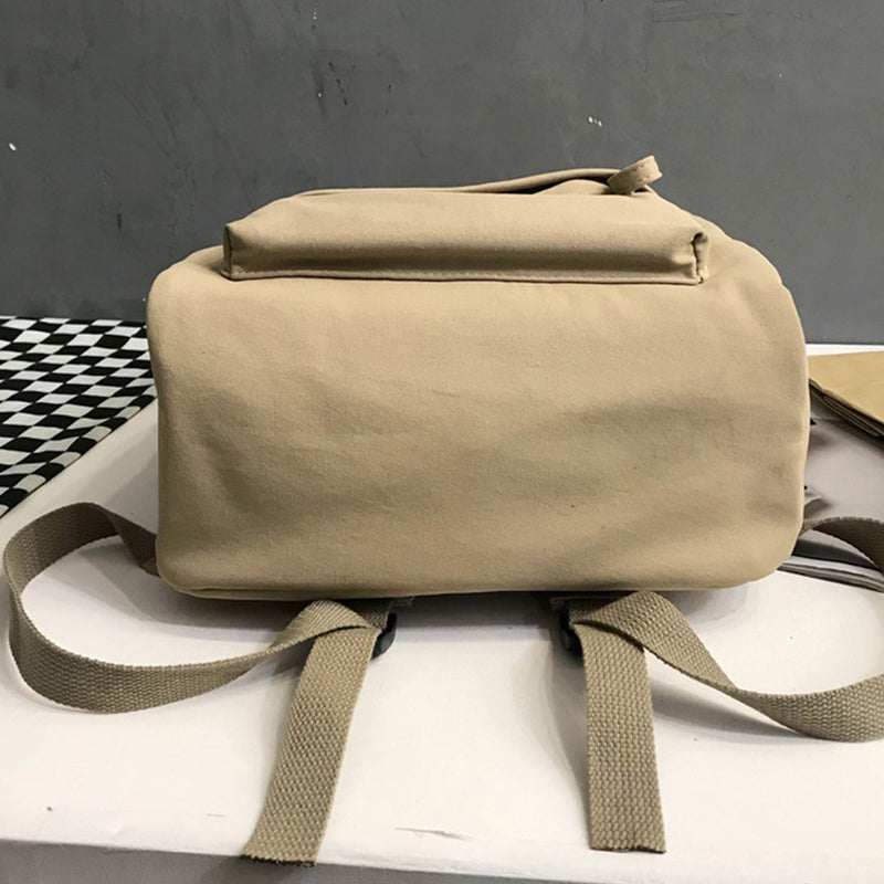 Large zip cotton backpack bag on table.