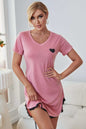 Pink heart graphic lace trim night dress with V-neck and short sleeves.