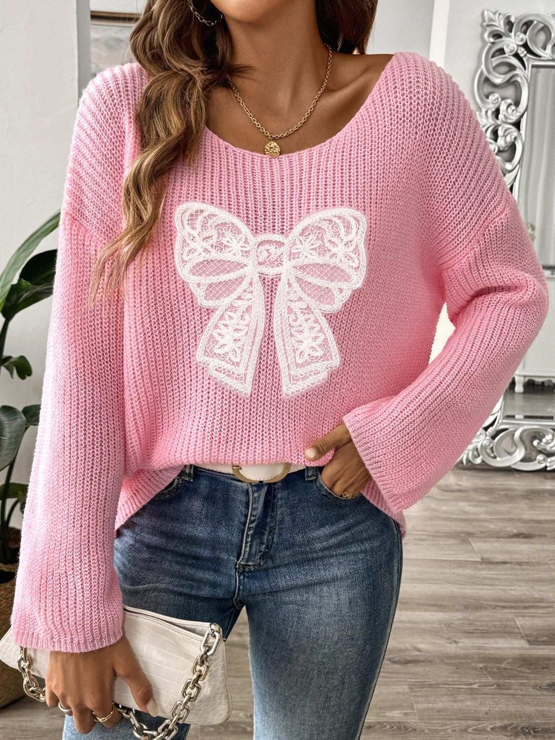 Pink bow boat neck long sleeve sweater with lace detail, made of 100% polyester.