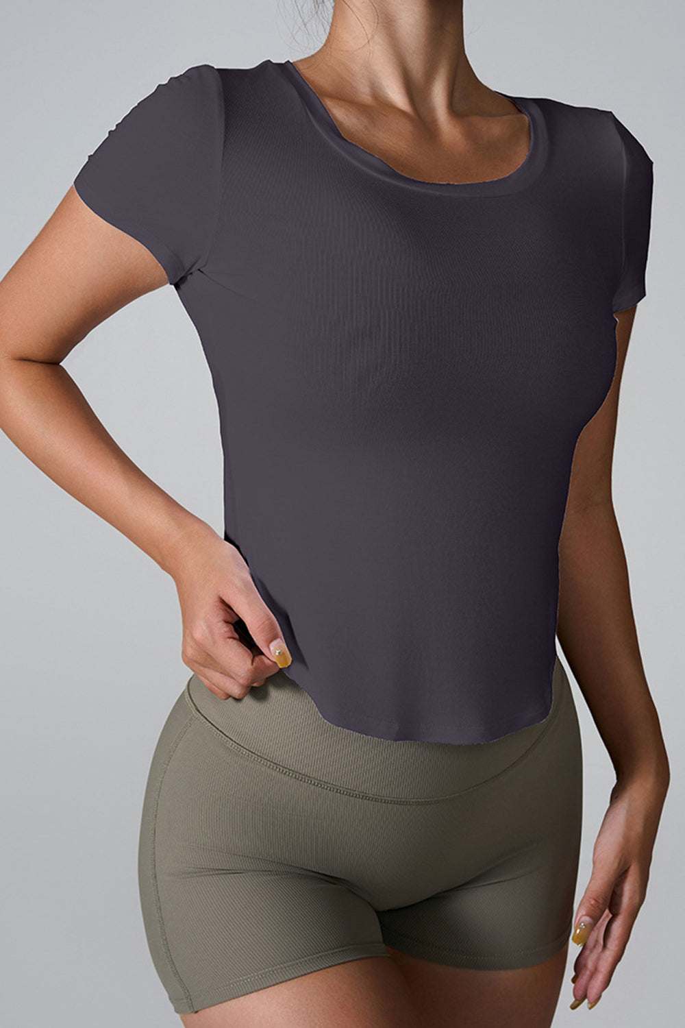 Cutout round neck short sleeve active t-shirt in black, stretchy cotton-elastane blend.