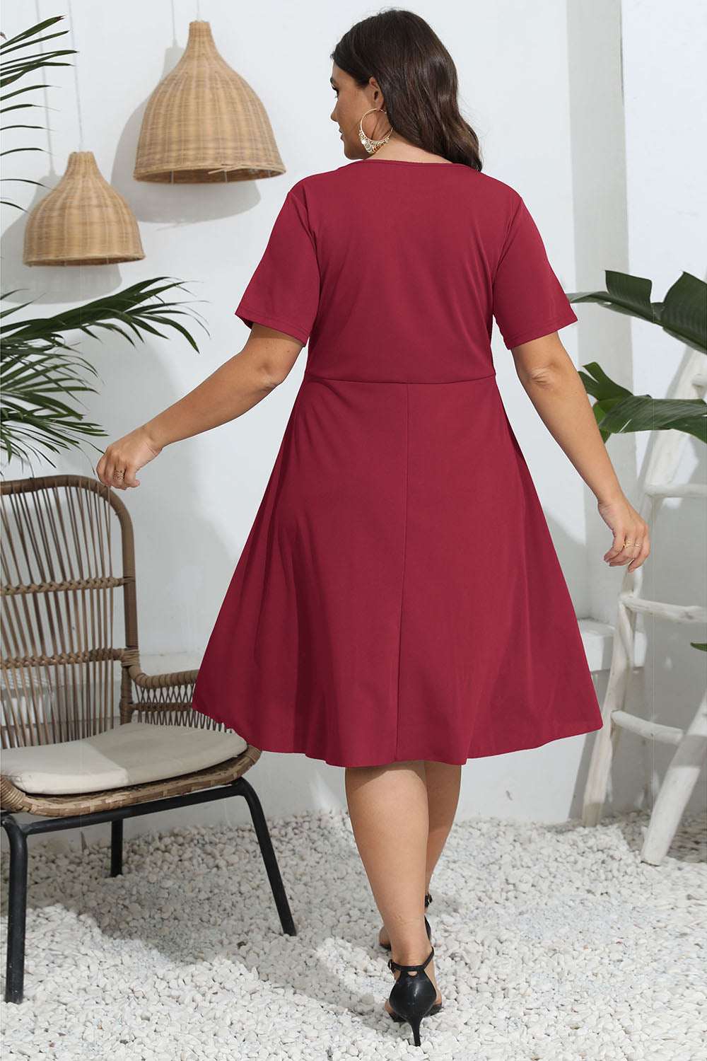 Plus size red round neck openwork dress with short sleeves.