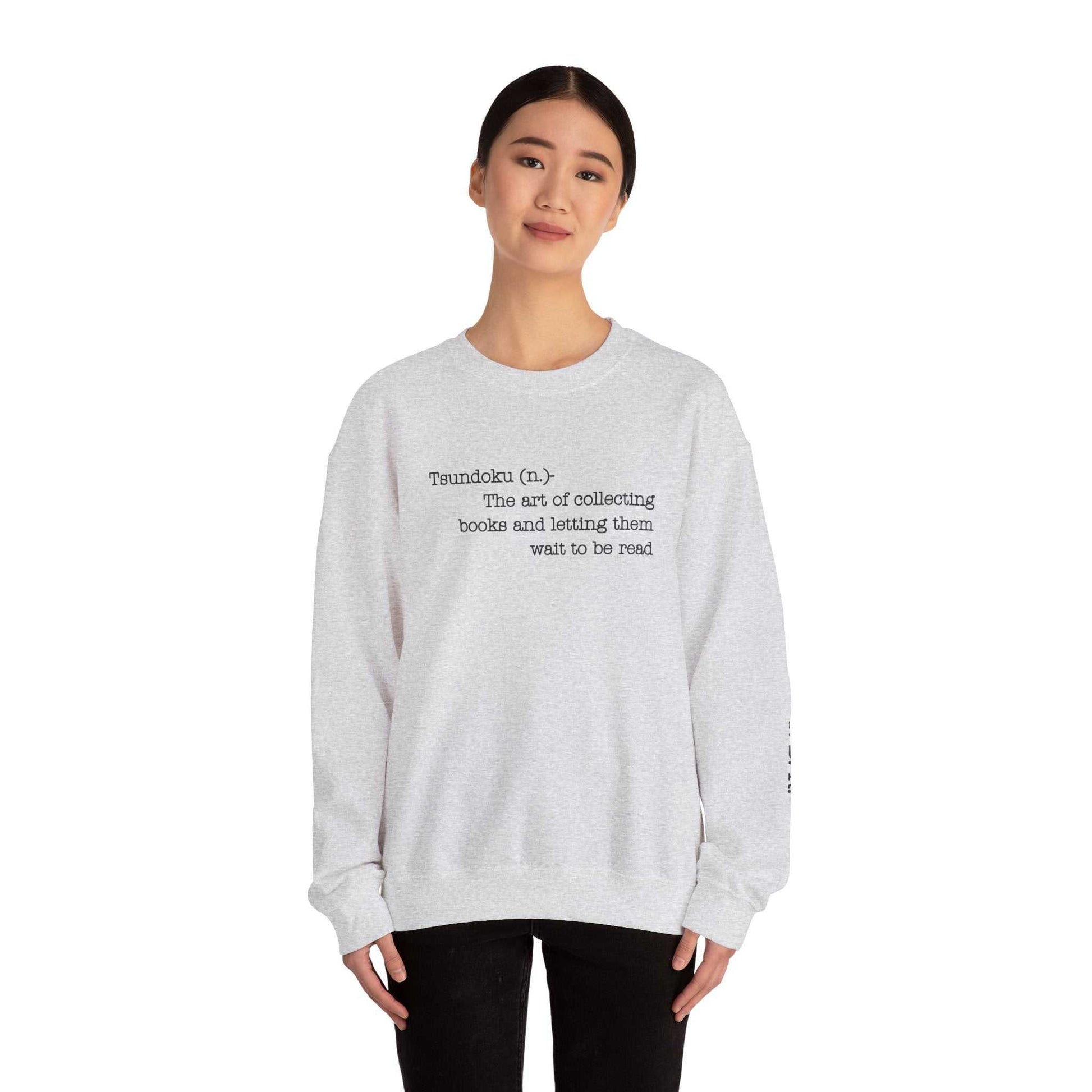 Tsundoku crewneck sweatshirt with book-themed design, featuring "Tsundoku" definition and T.B.R initials, ideal for book lovers.