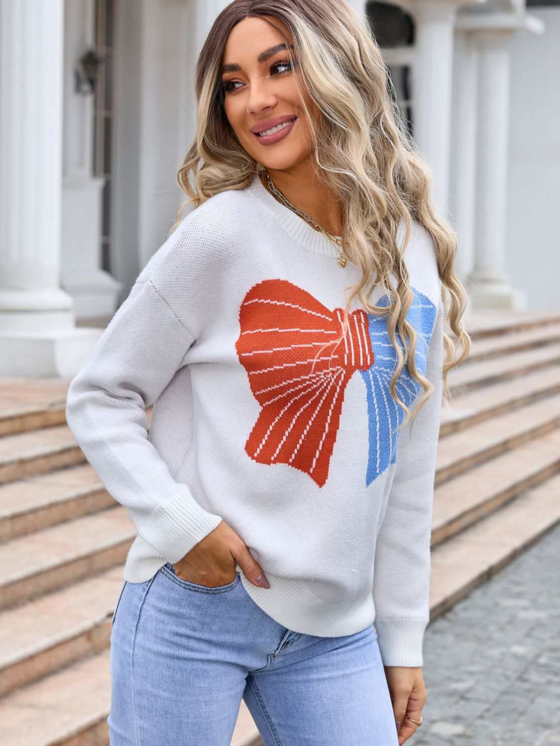 Angel Wings Bow Round Neck Dropped Shoulder Sweater with moderate stretch and acrylic material.