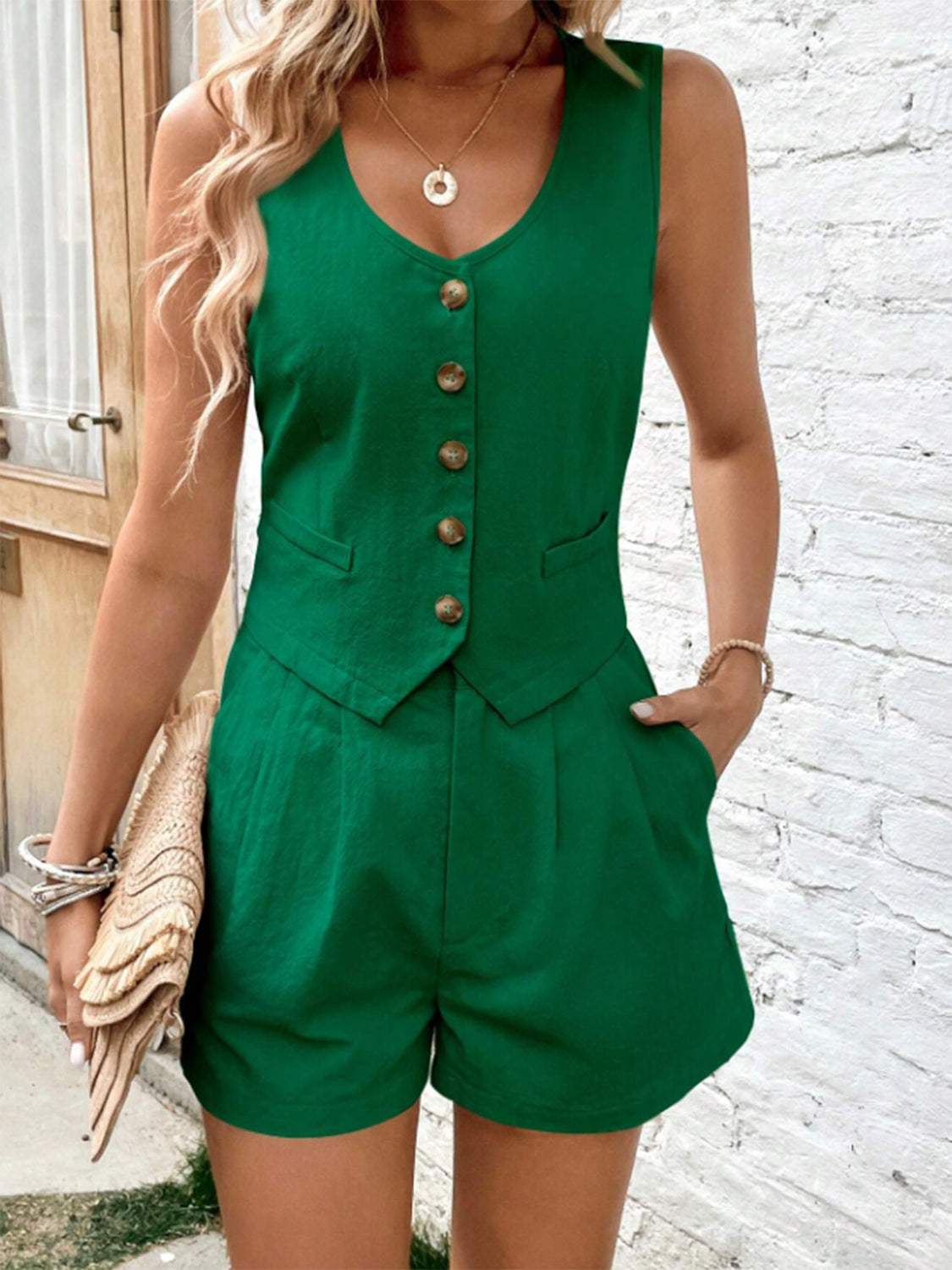 Green scoop neck sleeveless top and shorts set with button accents and pockets.