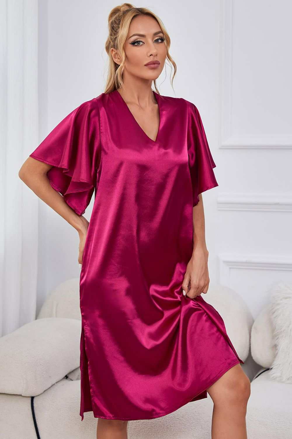 Satin V-neck night dress with flutter sleeves and side slit in solid color.