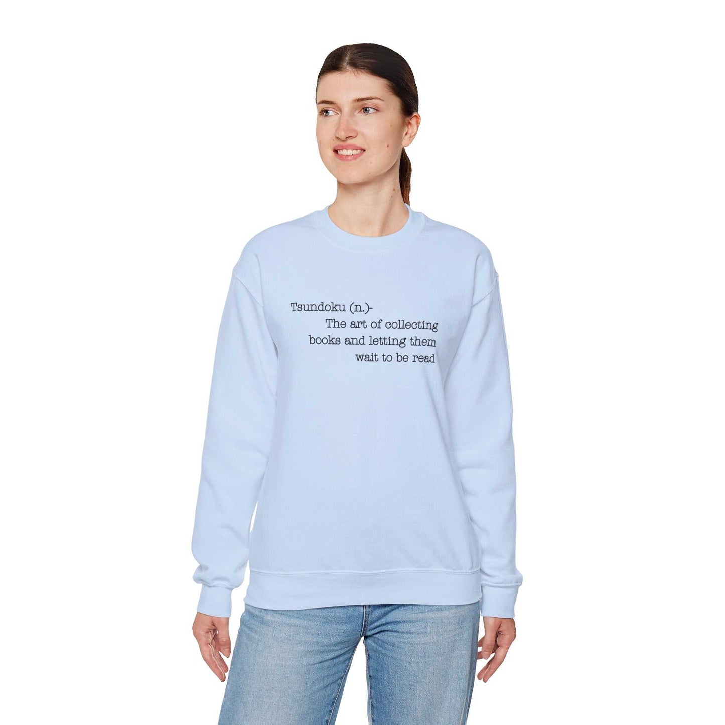 Light blue "Tsundoku" crewneck sweatshirt with Tsundoku definition on the front, ideal for book lovers.