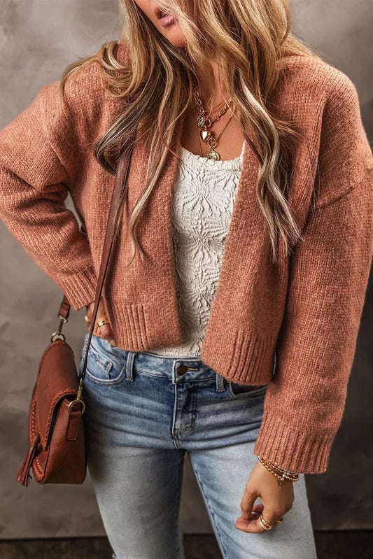 Open front dropped shoulder cardigan in brown, styled with white top and jeans.