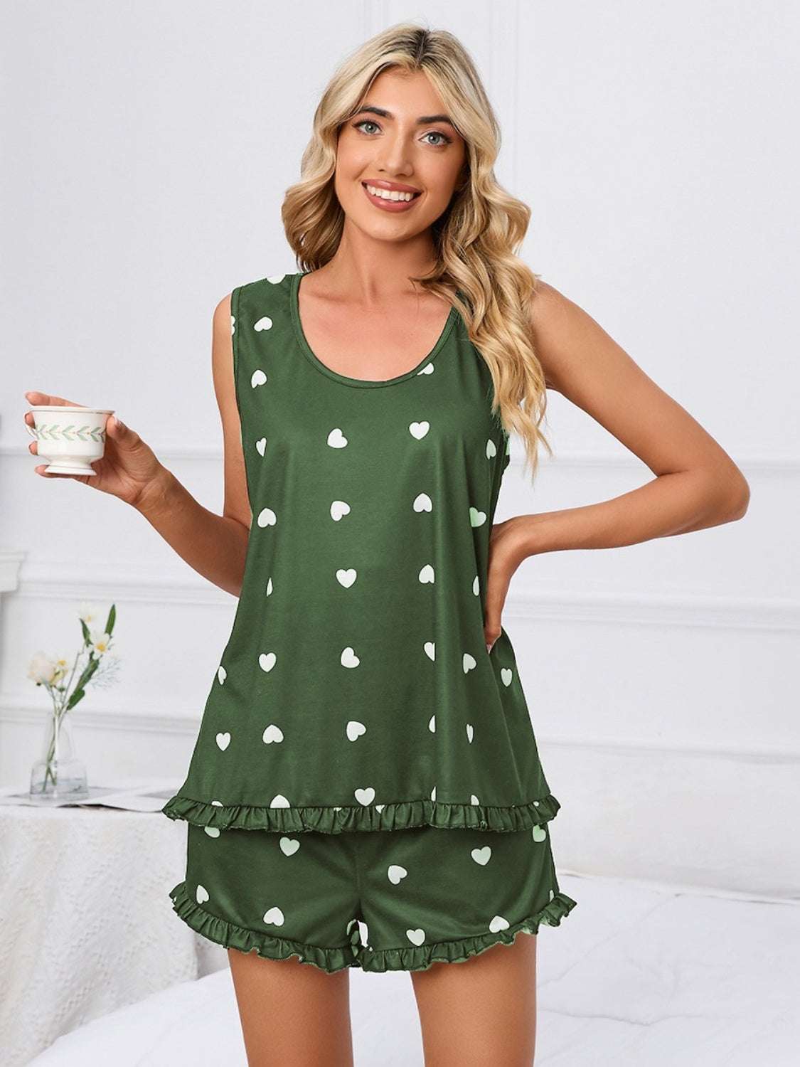 Heart scoop neck tank and shorts lounge set with white heart pattern on green fabric.