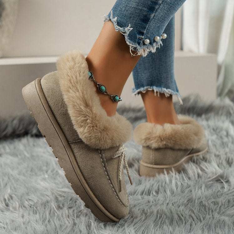 Thermal fuzzy tied round toe boots on a rug with pearl detail jeans.