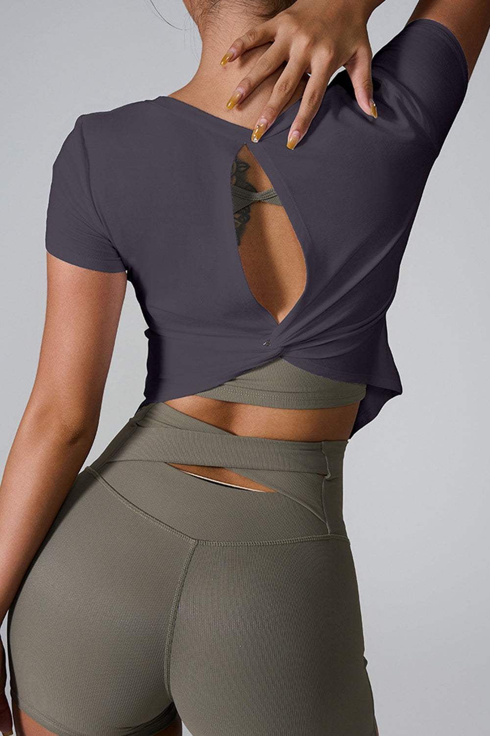 Cutout round neck short sleeve active t-shirt, highly stretchy cotton blend, back view.