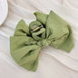 Green polyester bow hair claw clip, 5.1 inches long.