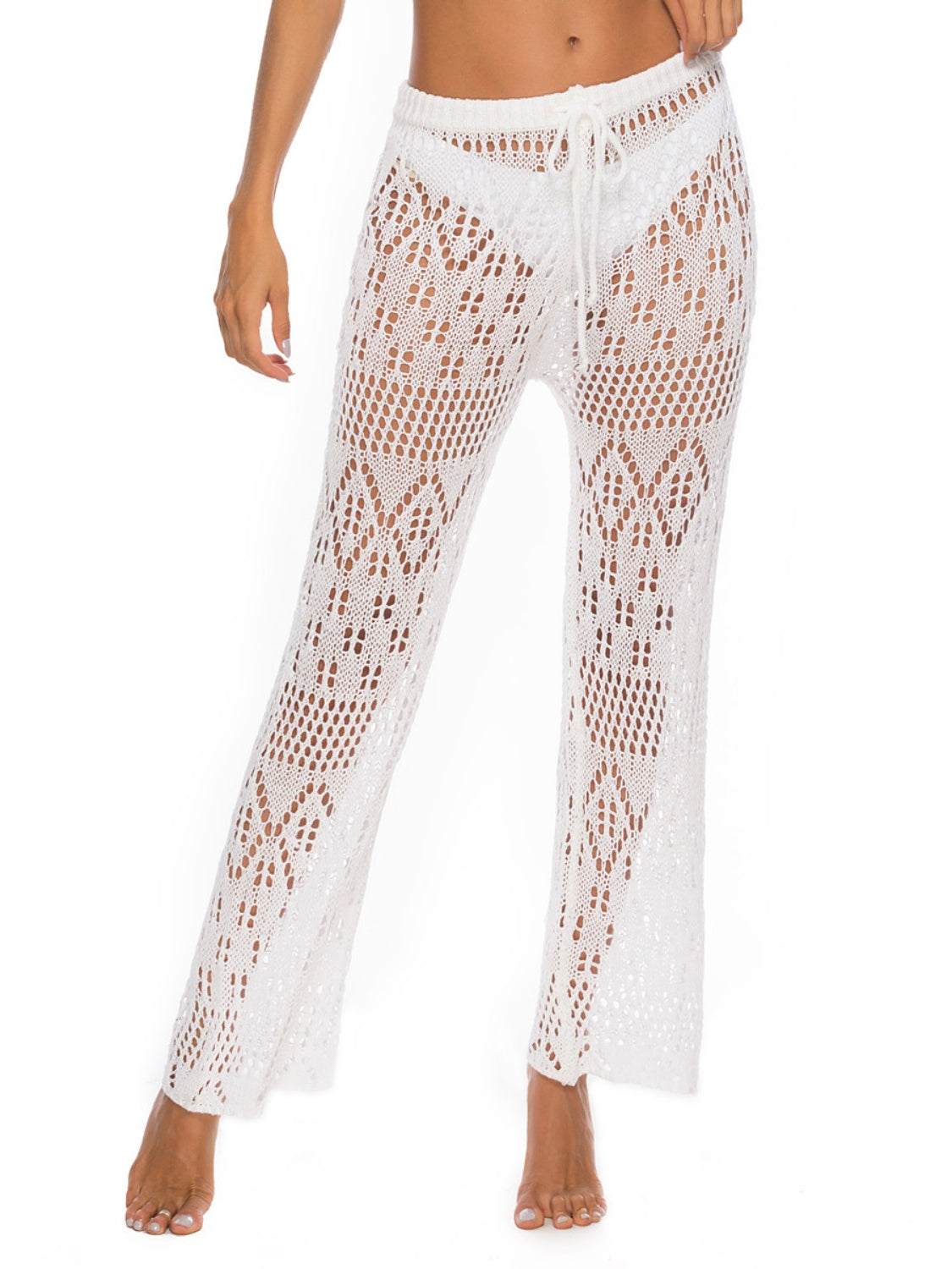 Women's cutout straight swim pants in white with moderate stretch and polyester material.