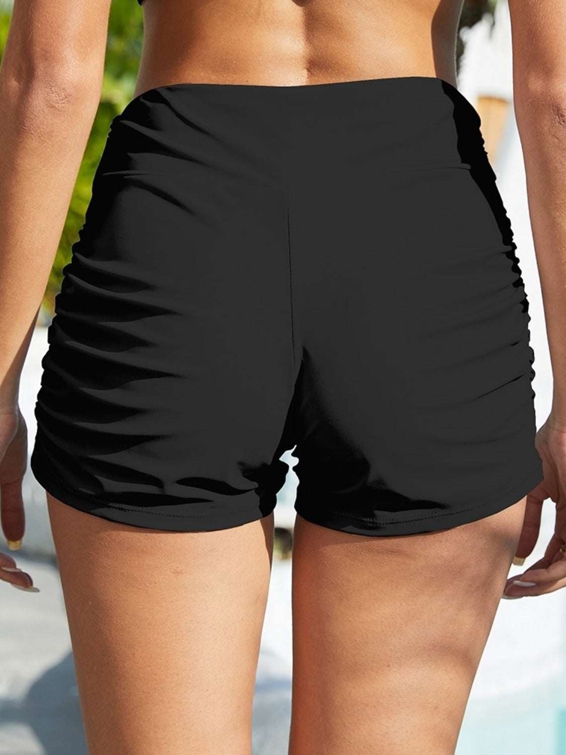 FAM-FAM Ruched Mid-Rise Waist Swim Shorts in black, slightly stretchy polyester-spandex blend.