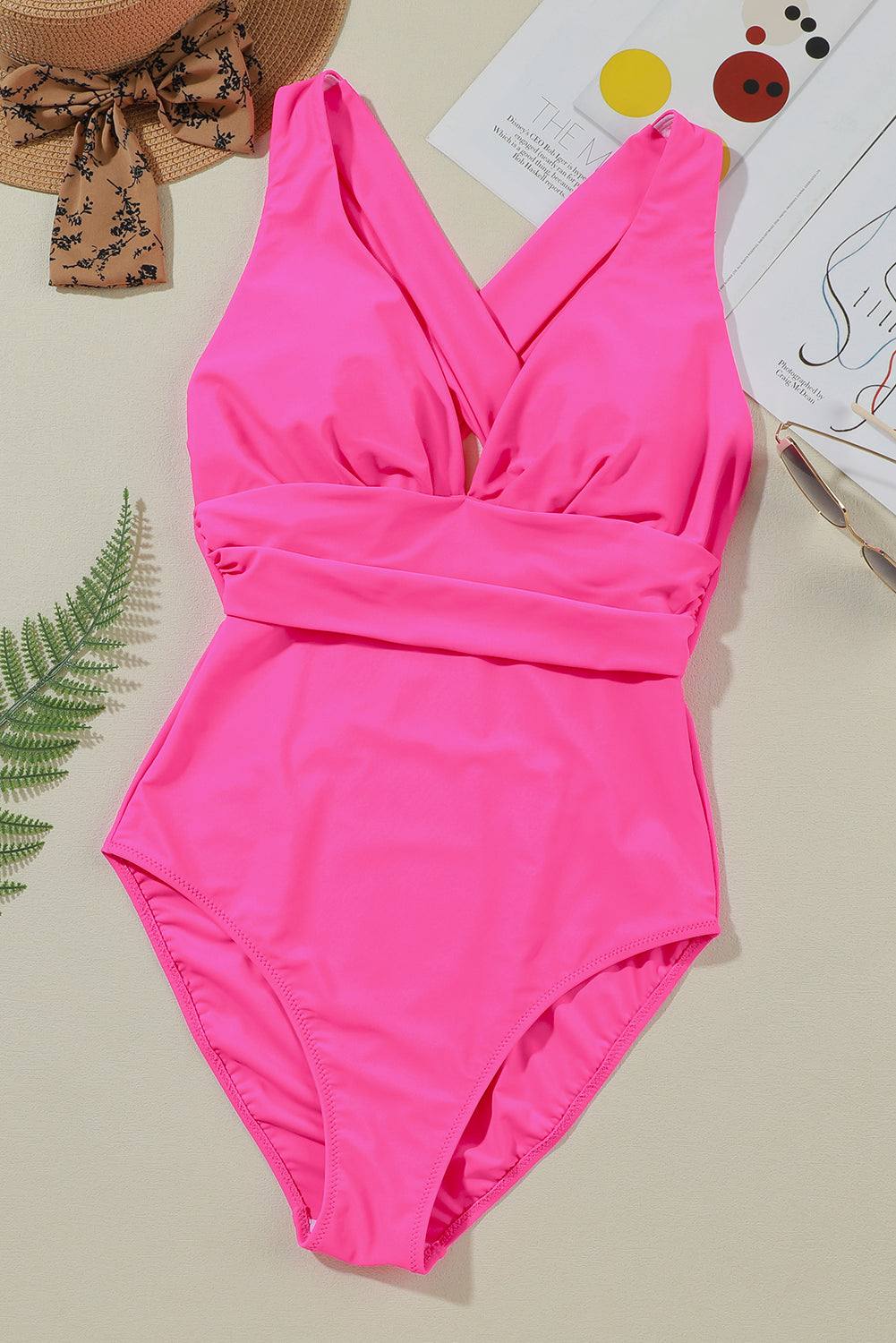 Pink crisscross wide strap one-piece swimwear with removable padding.