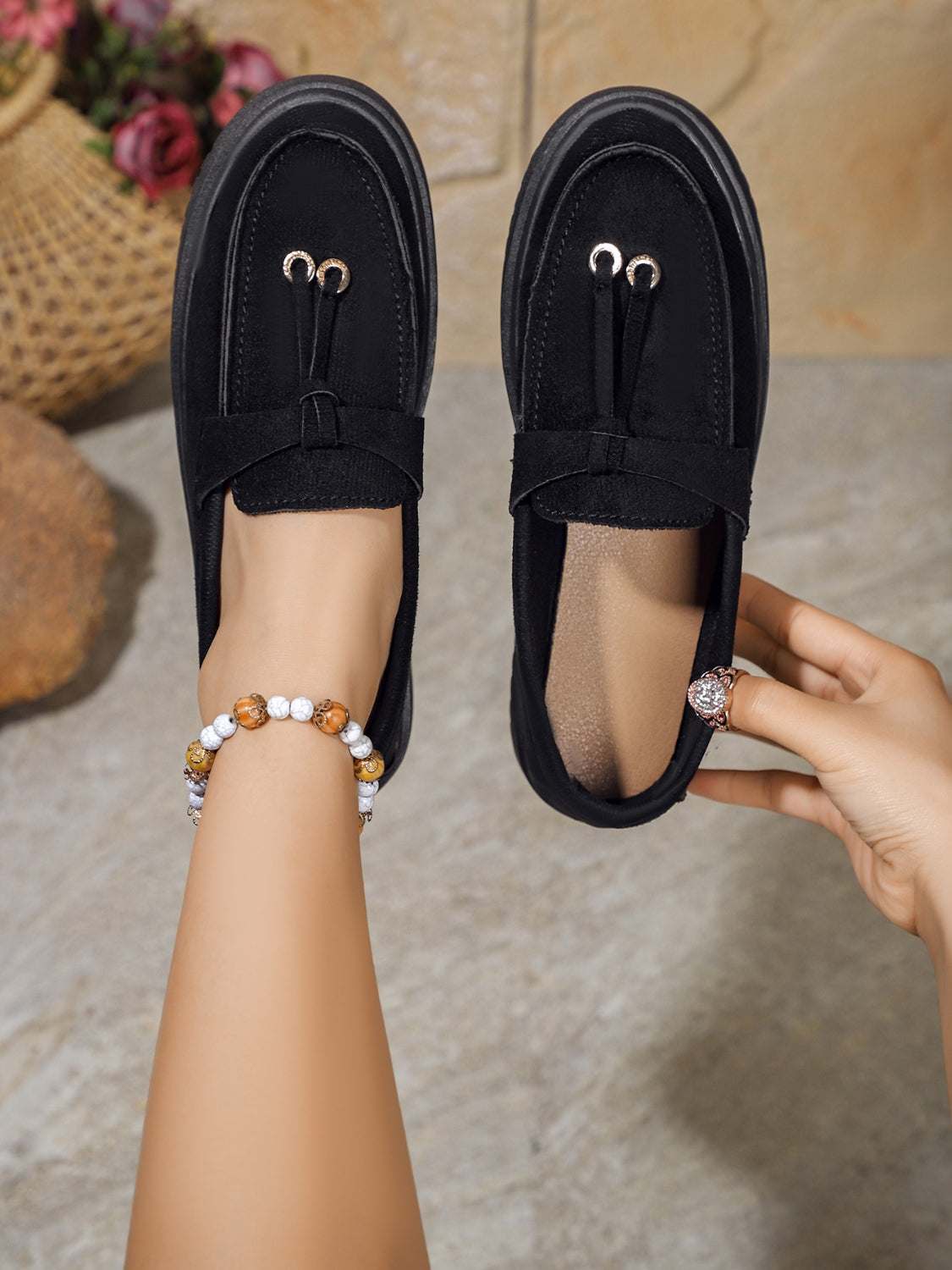 Round toe flat slip-ons in black rubber and polyester.