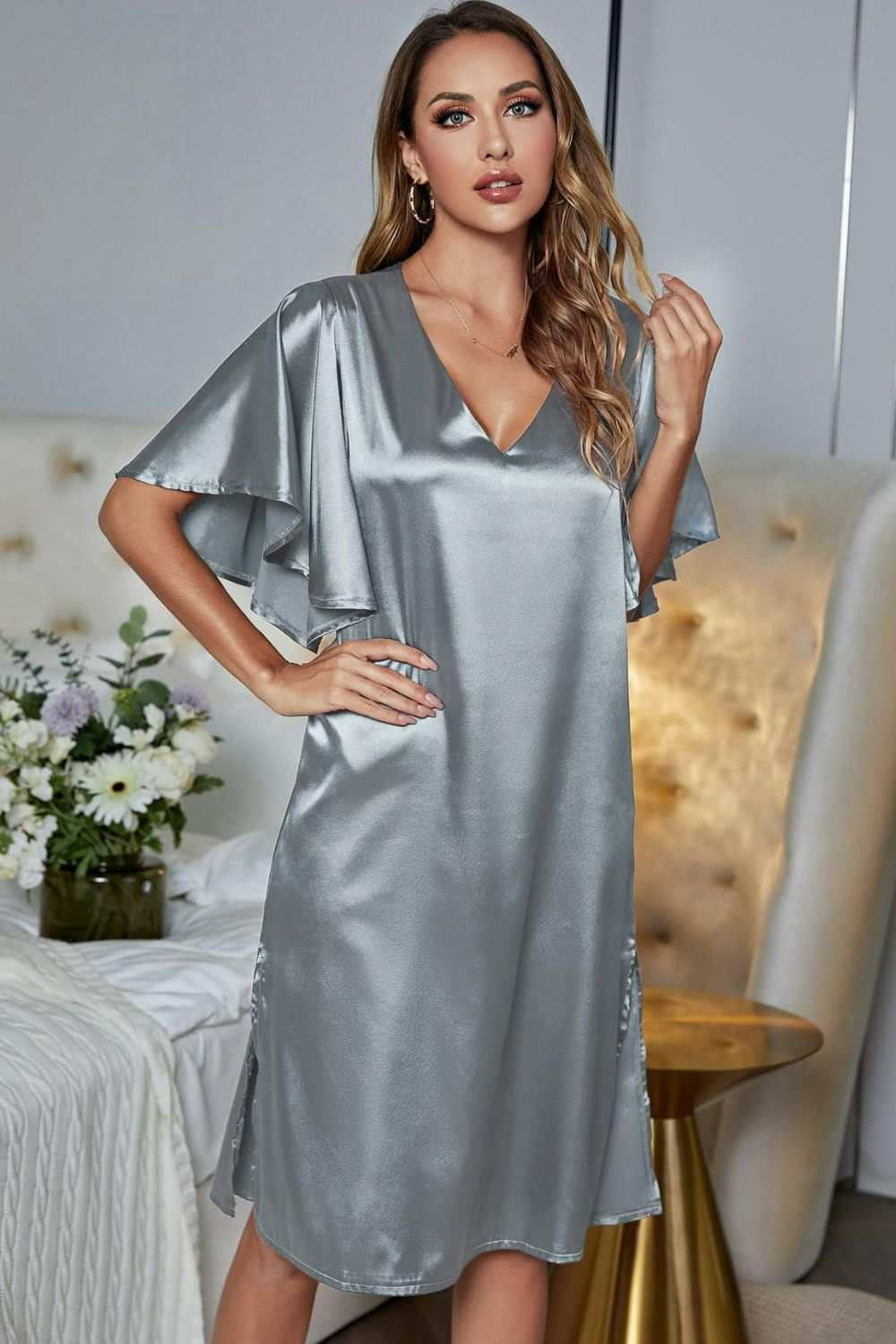 Satin night dress with flutter sleeves, V-neck, and side slit in a solid color.