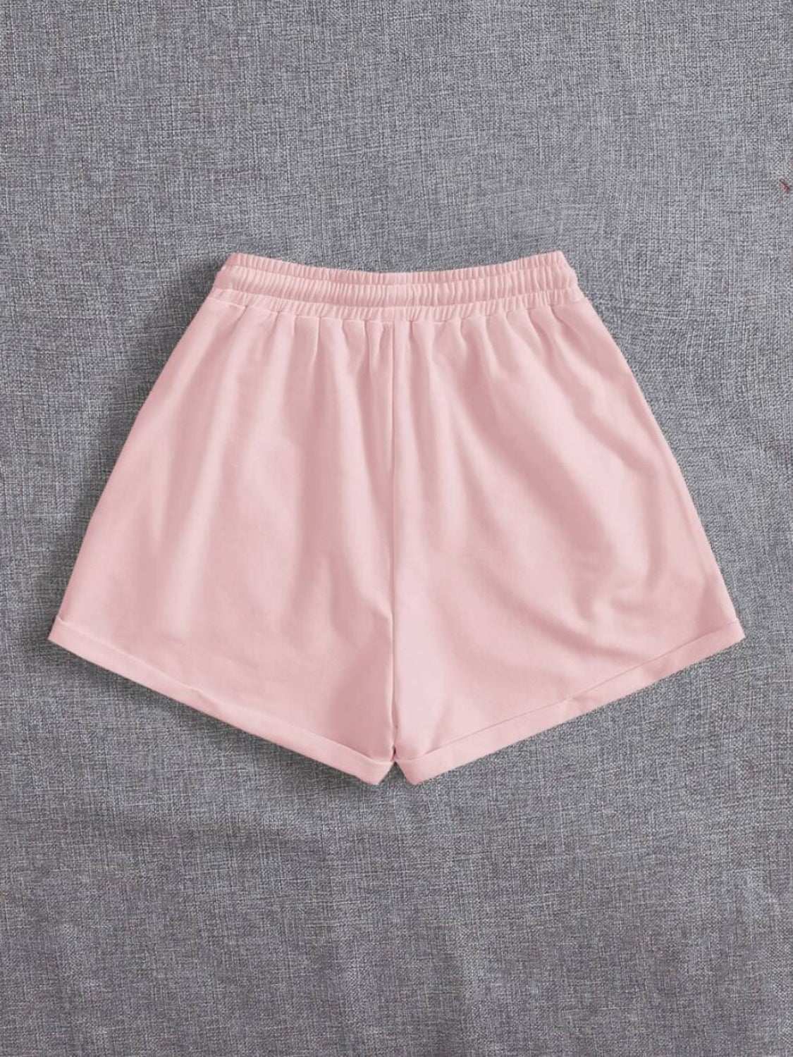 Pink drawstring pocketed elastic waist shorts made of 100% polyester.