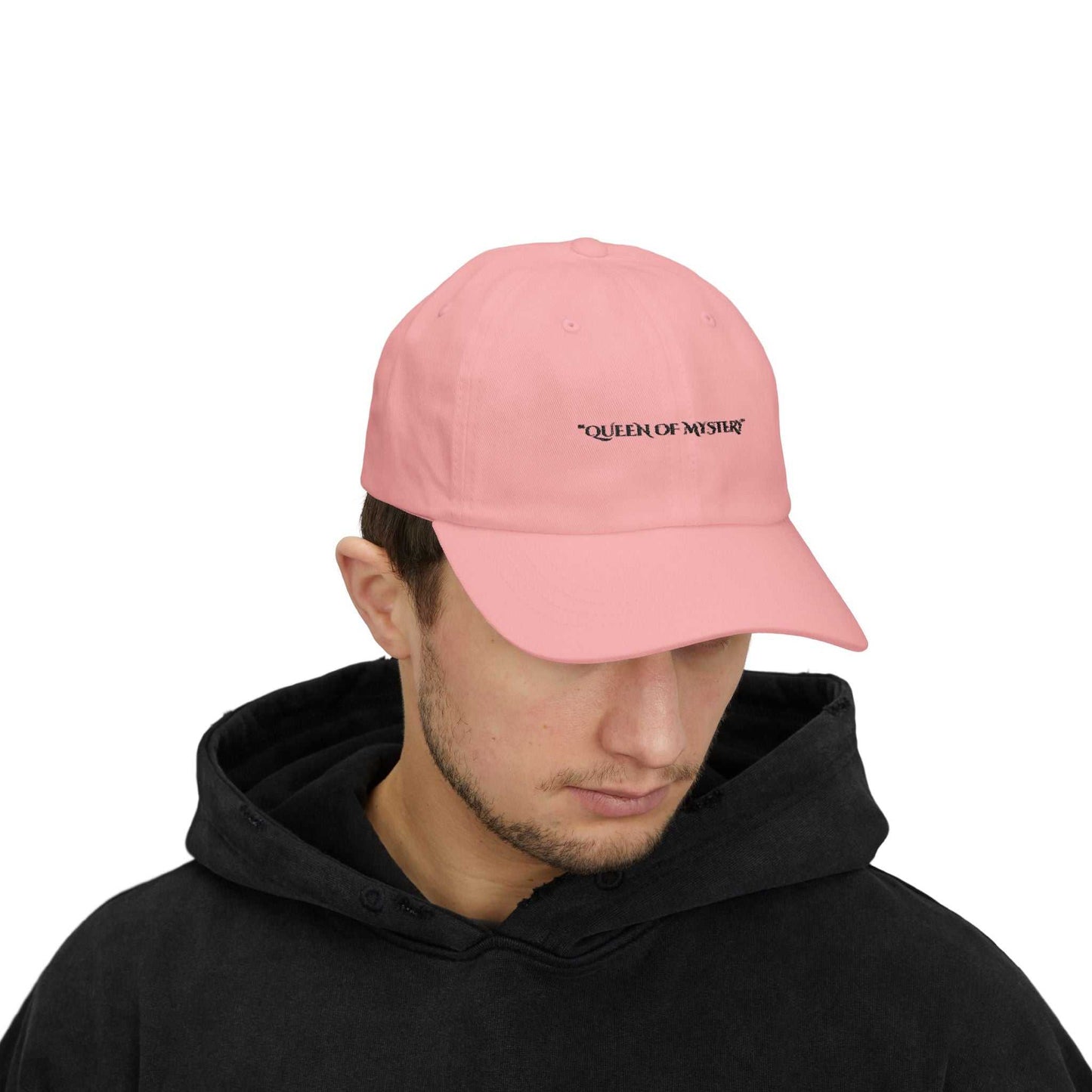 Pink classic dad cap with "Queen of Mystery" text, feminine and empowering design, versatile accessory.