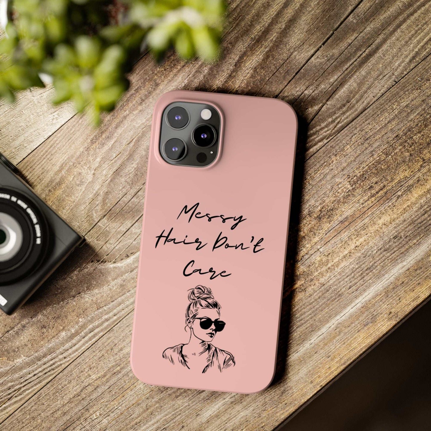 Baby pink phone case with "Messy Hair, Don't Care" quote, featuring girl with messy bun and sunglasses; stylish and durable design.