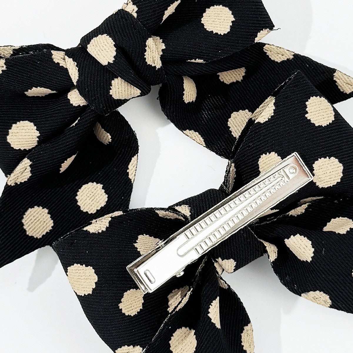 2-Piece Polka Dot Bow Hair Clip made of polyester, black with beige spots.