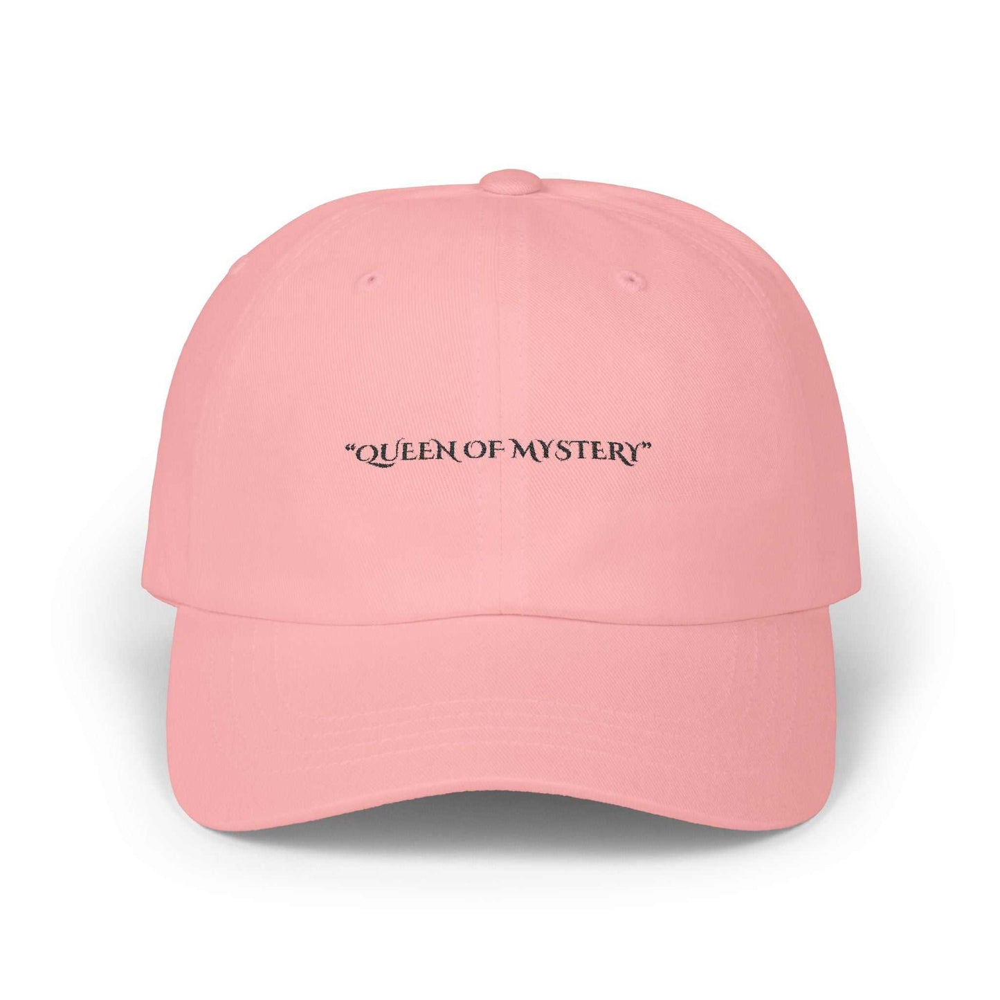 Classic dad cap in pink with "Queen of Mystery" text, featuring a 6-panel structure and precurved visor.