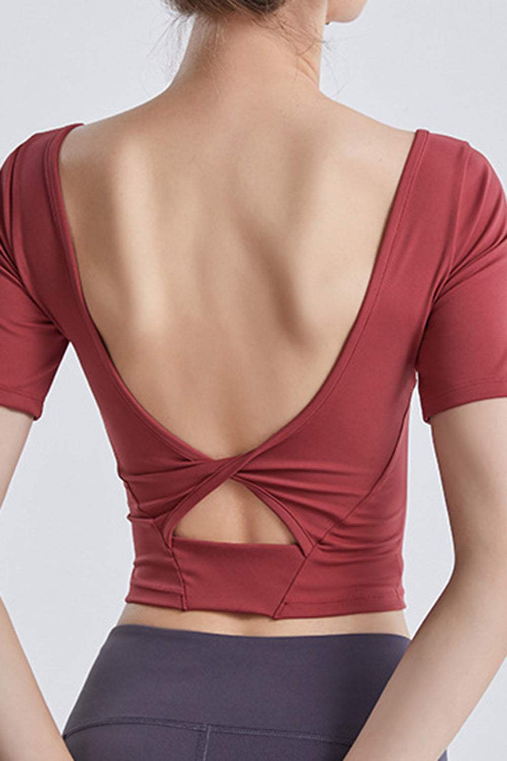 Back view of cutout backless round neck active t-shirt in red.