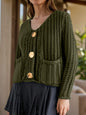 Button down long sleeve cardigan in olive green with large buttons and front pockets.