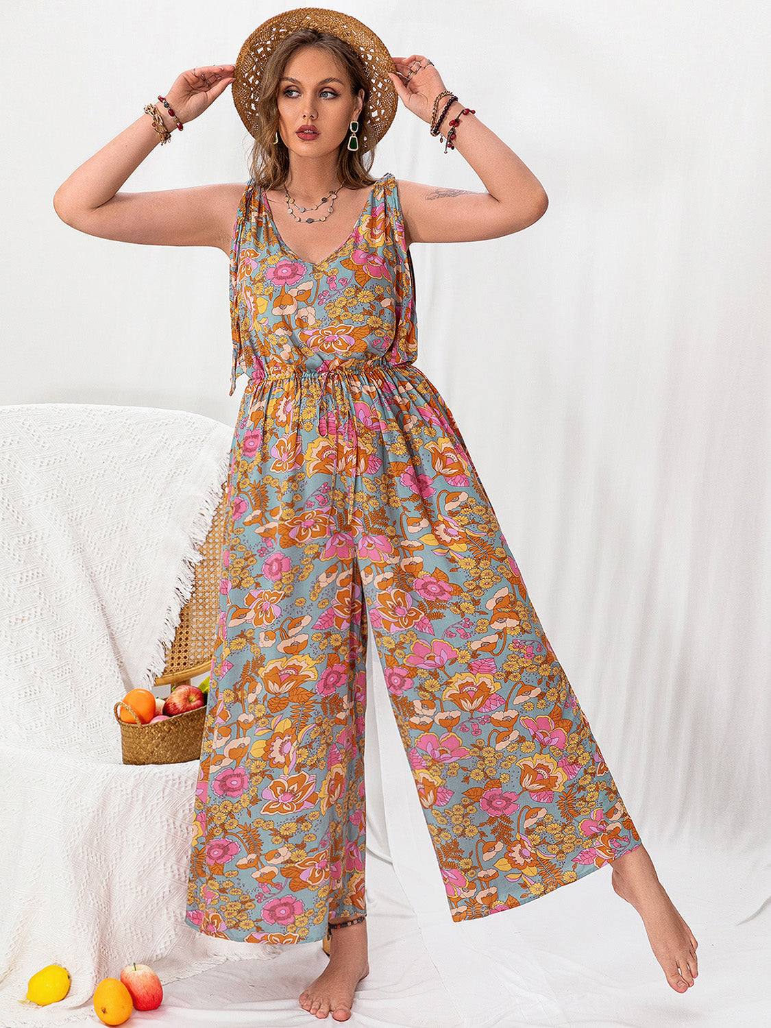 Plus size printed wide leg sleeveless jumpsuit with a tied backless design.