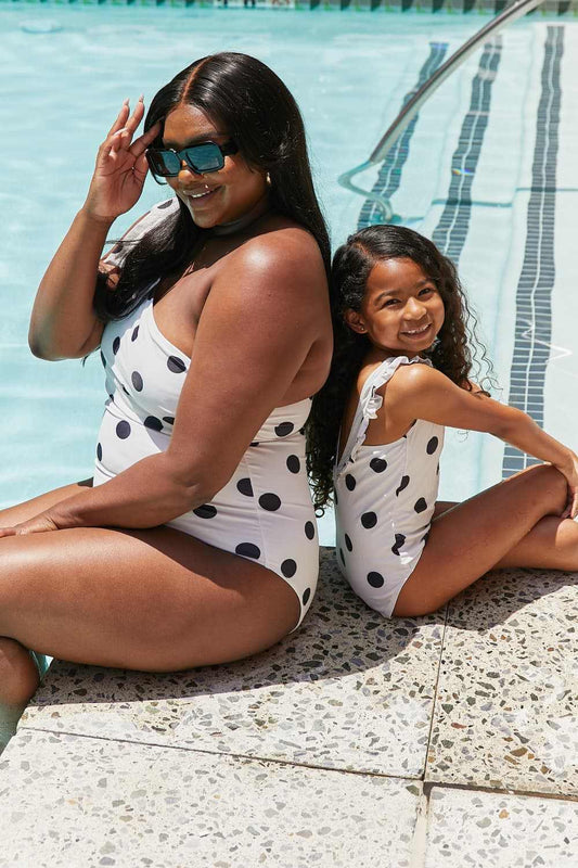 Marina West Swim Deep End polka dot one-shoulder swimsuits by poolside.