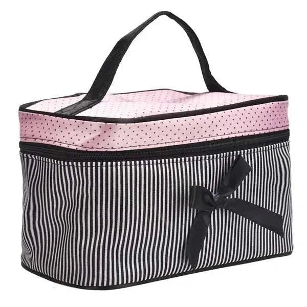 Striped cosmetic bag with bow, zipper closure, and handle for makeup and toiletry storage.