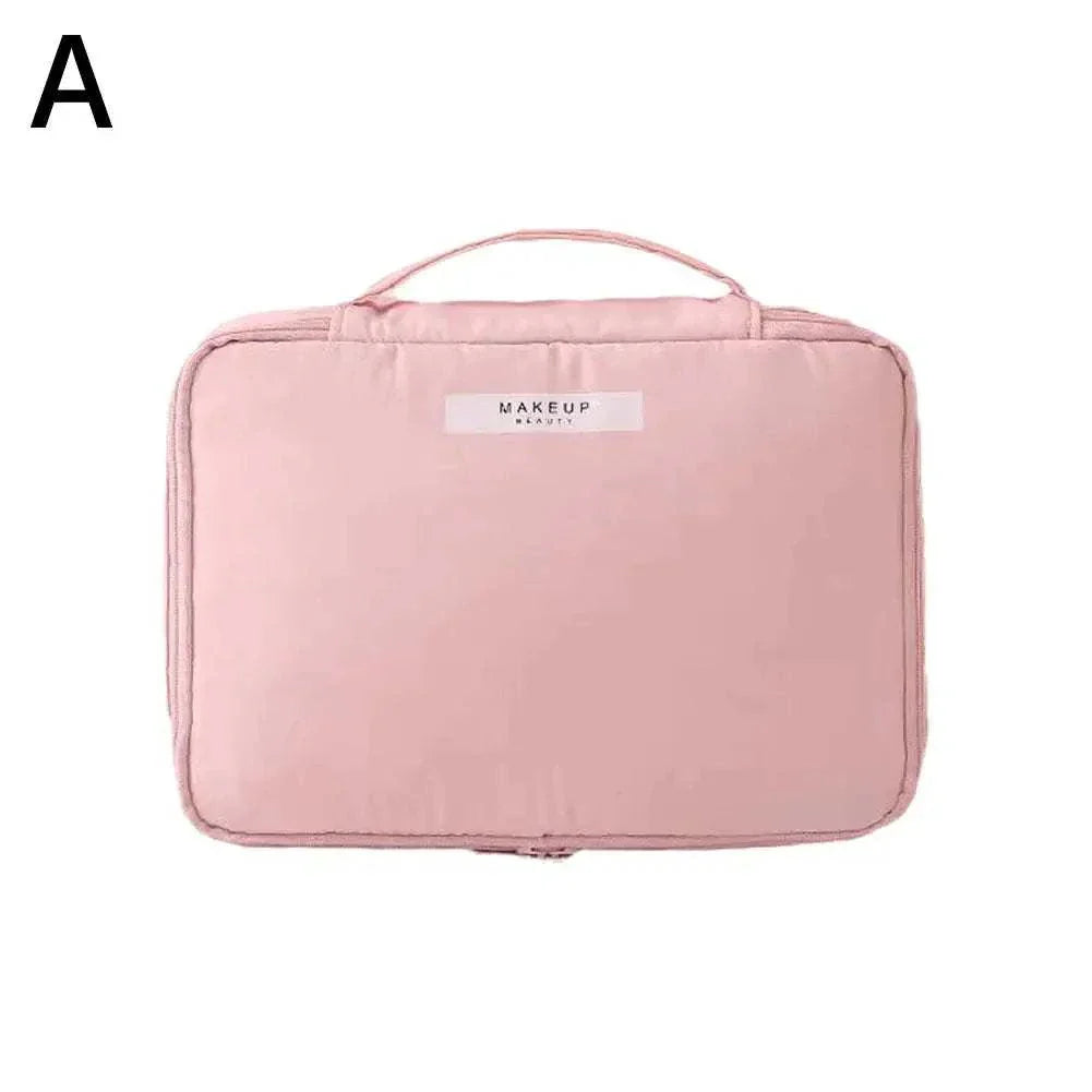 Pink waterproof portable cosmetic bag for female toiletry and makeup storage.