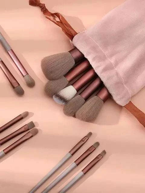 Professional makeup brush set with soft blush and foundation brushes, 13-piece kit in bag.