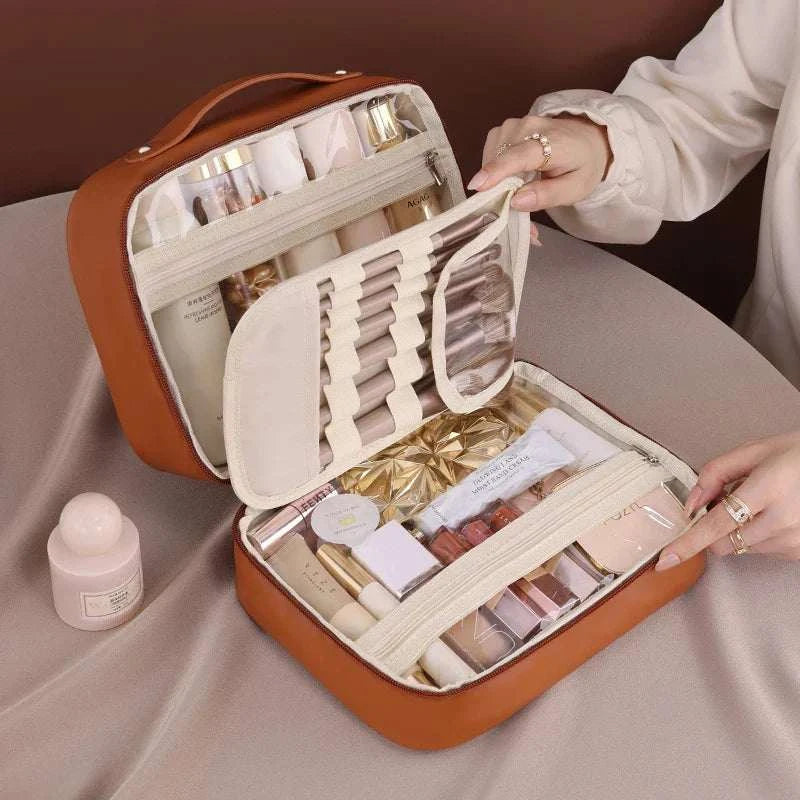 Women PU leather double-layer travel makeup bag with zipper, multi-compartment waterproof toiletry organizer on a table.