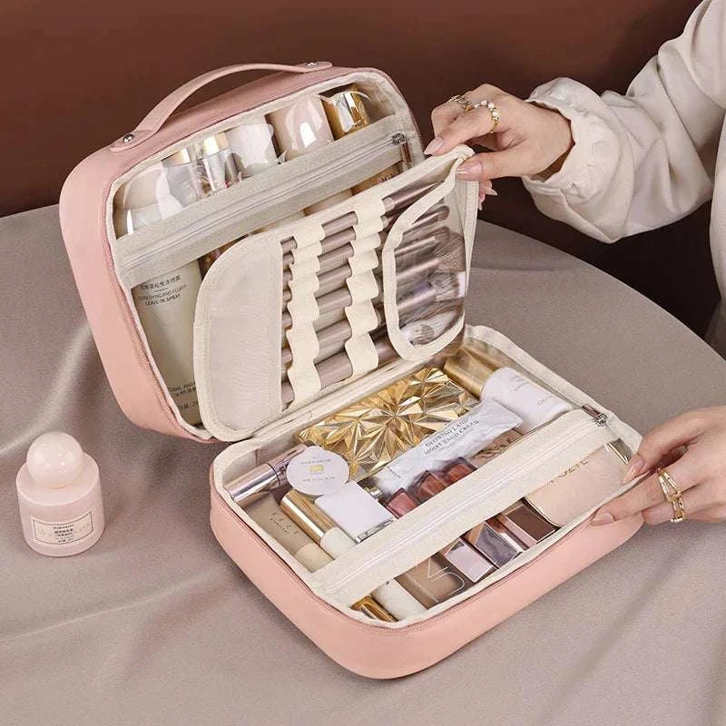 Women PU leather double layer travel makeup wash clear cosmetic bag with zipper, featuring multiple compartments for toiletries, shown on a table with makeup items.